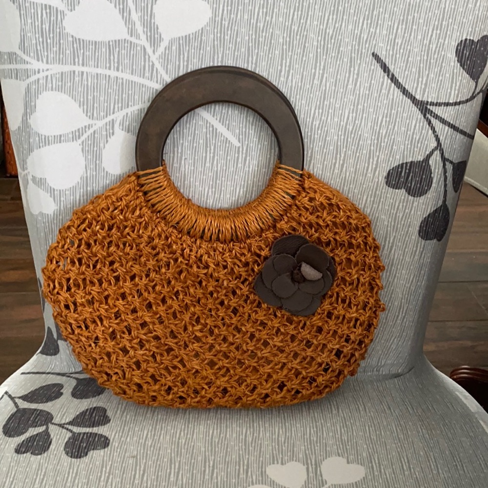 Straw purse with brown round handles. Pre owned see photos
